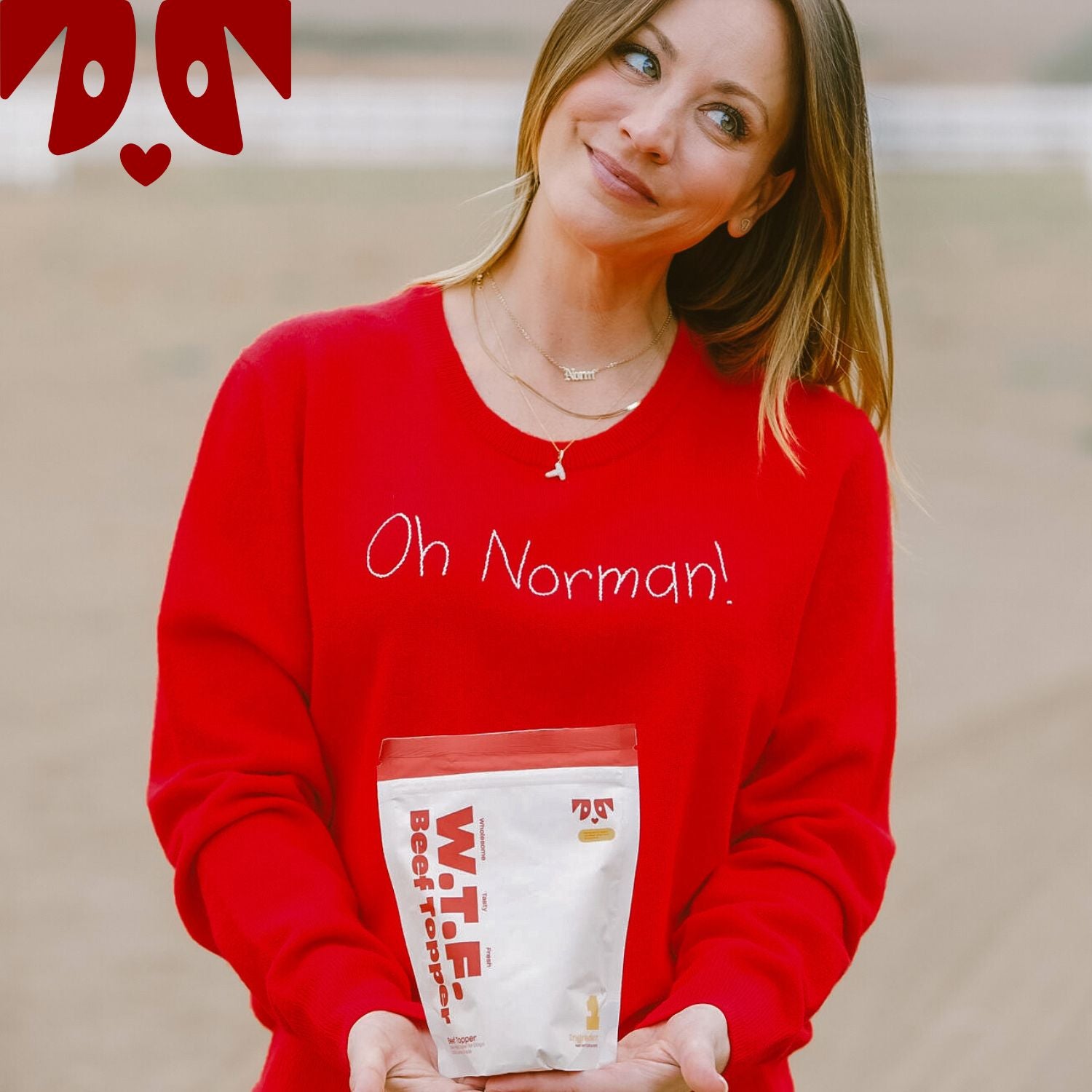 Woman wearing a red sweater with text 'Oh Namaste' holding a white package labeled 'WTF Beef Topper'
