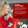 Kaley Cuoco holding a cat with a red note titled 'A note from Kaley' containing adoption information and a signature