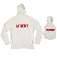 Back view of cream dog hoodie with red THERAPIST text beside matching cream human hoodie labeled PATIENT on white background