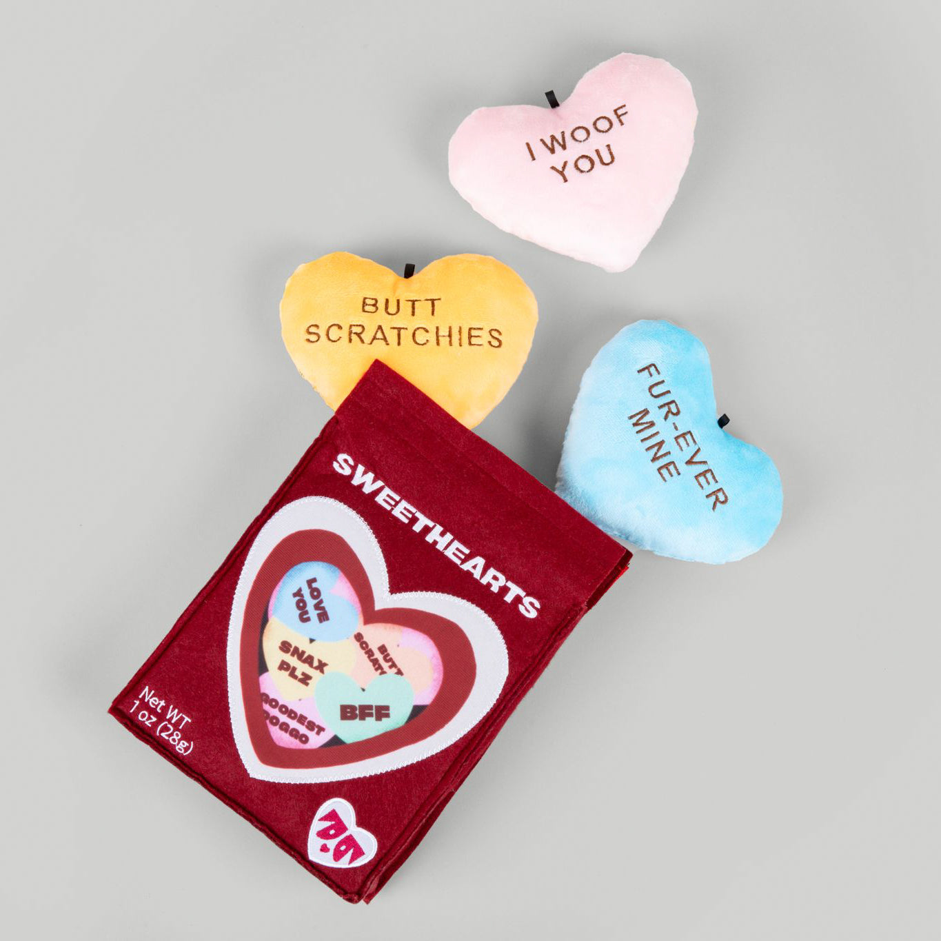Recycled plush toy with a heart design and text "I Effing Love You!" surrounded by three plush hearts labeled "You Are My Sunshine", "Love You", and "Be Mine" on a light background.